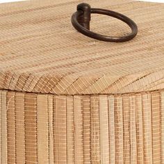 a close up of a wooden box with an iron ring on it's lid