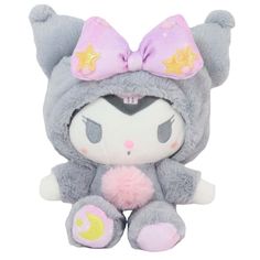 a stuffed animal with a pink bow on it's head and ears, sitting next to a white background