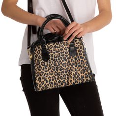 "Step out in style with this snazzy leopard print bag that is durable. Great for work, church, or dinner with your special someone. It has a single zippered top closure. Inside has a deep main compartment, a zippered pocket, and two side pockets that can be used for holding your phone, cosmetics, etc. The adjustable fabric shoulder strap is removable, so it can double as a stylish handbag -- perfect for any  occasion. Length = 9\" Height = 8\" Width = 3.5 Shoulder strap length = 49.5\" Handle length = 12.5\"" Leopard Print Bag, Unique Handbag, Stylish Purse, Black Handles, Printed Purse, Printed Handbags, Black Handle, Shoulder Handbag, Shoulder Handbags