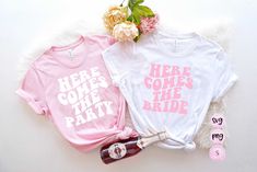 two bride t - shirts are sitting next to each other