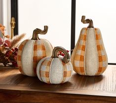 two decorative pumpkins sitting on top of a wooden table