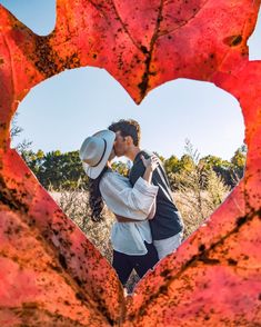 a man and woman kissing in the shape of a heart