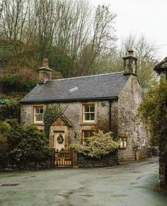 an old stone house with a clock tower