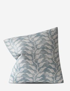 a blue and white pillow on a white background