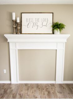 a white fireplace mantel with a sign above it that says, blessing the lord my god