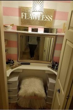 an open closet with a vanity, mirror and stool in the corner that has a fur rug on it