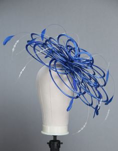 This is a stunning design for a wedding or ladies day at the races. A looped fascinator hat with three layers of different-sized loops. Decorated with coque feathers in one or two colours. I've shown it here in Royal Blue and White however you can have this style all in one colour if you like or you can choose up to 2 colours of feathers. If you want the hat all in one colour then just choose the same colour from both drop-down boxes This item will be set on a silver metal headband unless you st Blue Evening Headpiece For Royal Ascot, Blue Fascinator For Royal Ascot Evening, Blue Evening Fascinator For Royal Ascot, Blue Headpieces For Royal Ascot, Blue Mini Hats For Royal Ascot Event, Blue Mini Hats For Royal Ascot, Blue Fascinator For Royal Ascot, Blue Fascinator For Royal Ascot Races, Blue Headpiece For Kentucky Derby