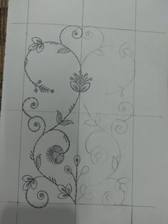 a drawing of flowers and swirls on a white tile wall next to a piece of paper