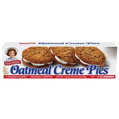 three oatmeal creme pies in a carton on a white background