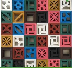 colorful blocks are arranged in the shape of an abstract pattern, with green letters on each side