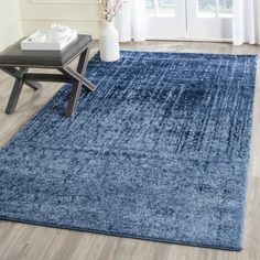 a blue area rug in a living room