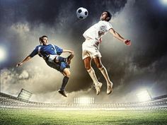 two men are playing soccer against each other in the air on a stadium field with bright lights