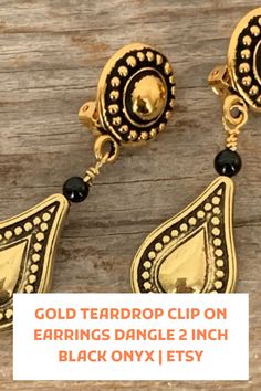 Gold teardrop clip-on earrings dangle. These pretty gold teardrop clip-on earrings dangle prettily from your ear lobes! The short earrings feature gold metalized drops that are hollow on the inside. They have an antique finish that is complemented with petite black onyx beads. The lightweight Short Earrings, Peach Jewelry, Light Weight Jewelry, Onyx Bead, Light Weight Earrings, Antique Finish, Earrings Dangle, Teardrop Earrings, Earings Piercings