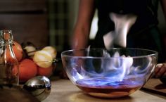 a video demonstrating how to use a glass bowl with blue flames in the bottom and inside