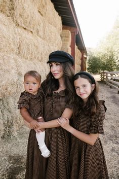 Brown and black plaid woven fabric Boat neckline with collar and functional drawstring bow Half length puff sleeve with elastic closure Midi length skirt with pockets Hidden back zipper Bodice and skirt lined Non-stretch fabric matching mommy and me style with styles for the whole family flowy floral dresses, earthy tones, vintage-inspired layers, cottagecore accessories, soft autumn hues, cottagecore dress, fall dress, fall fashion, family photo, gingham, brown dress Fall Brown Midi Dress With Puff Sleeves, Cottagecore Accessories, Maple Dress, Brown Gingham, Fabric Matching, Flowy Floral Dress, Drawstring Neckline, Fashion Family, Cottagecore Dress