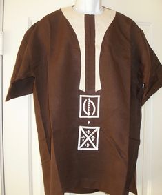 An Authentic African Linen Shirt with embroidered Adinkra Symbols. This is available in a 2xl Traditional Crew Neck Cotton Shirt, Traditional Cotton Crew Neck Shirt, Traditional Brown Summer Tops, Traditional Crew Neck Cotton Top, Traditional Cotton Crew Neck Top, Traditional Short Sleeve Tops With Motif, Traditional Motif Fitted Top, Traditional Fitted Tops With Motif, Fitted Traditional Motif Tops