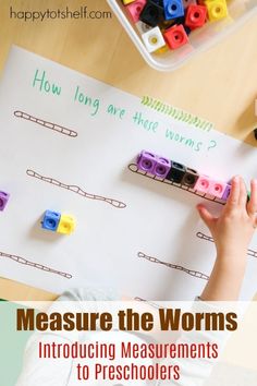 a child is playing with legos and measuring the words measure the worms on a piece of paper