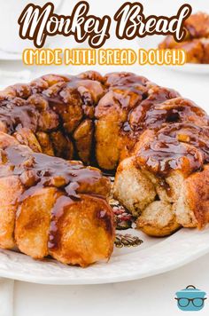 a monkey bread cake on a white plate with chocolate sauce drizzled over it