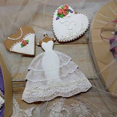 decorated cookies and wedding dresses on display for guests to enjoy at the reception table,