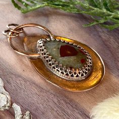 Puddingstone from Michigan, handcrafted into a cabochon and placed in a custom copper bezel setting. Pendant measures approximately 1.0 x 1.5 inches. Brass Cabochon Jewelry For Jewelry Making, Antique Teardrop Cabochon Jewelry, Hand Forged Rust Copper Jewelry, Artisan Oval Brass Jewelry, Rust Teardrop Handmade Jewelry, Vintage Handmade Rust Jewelry, Oval Bronze Copper Jewelry, Gold Copper Teardrop Pendant Jewelry, Spiritual Bronze Oval Jewelry