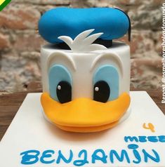 a close up of a cake with a donald duck face on it's head