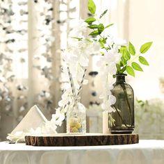 two vases with flowers are sitting on a table