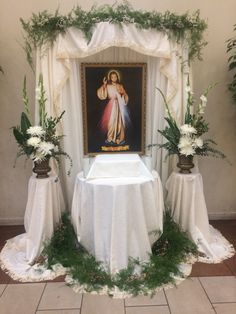 the altar is decorated with flowers and greenery