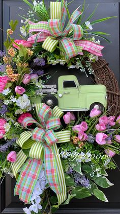 a wreath with a green truck and pink flowers