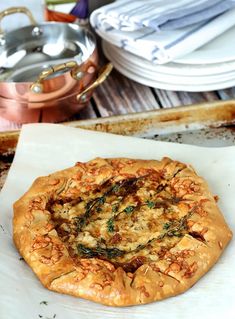 an uncooked pizza sitting on top of a white plate next to silverware