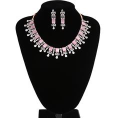 American Diamond bridal collar choker necklace studded with rose pink quartz and clear CZ stones encrusted on rose gold background. Necklace comes with a pair of matching earrings. This is very unique and beautiful Indian Necklace set studded high quality AD stones beautifully decorated work. Stone shape: emerald cut and Pear Necklace Length: 9 inches+ Length of Extender is 9 inches Earring Length: 1.75 inches Contents: 1 Necklace, 2 Earrings Best suitable for Party Wear / Fashion Wear for Any O Pink Crystal Jewelry Sets For Formal Occasions, Formal Pink Crystal Jewelry Sets, Elegant Pink Crystal Jewelry Sets, Elegant Pink Rhinestone Jewelry Set, Pink Crystal Jewelry With Diamond Accents, Pink Sparkling Stones Jewelry Set For Party, Pink Party Jewelry Sets With Sparkling Stones, Pink Jewelry With Sparkling Stones For Formal Occasions, Elegant Pink Diamond Jewelry Sets