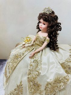 the doll is wearing a tiara and dress