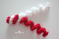 two crocheted red and white letters are shown