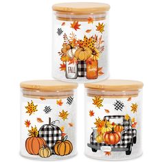 three glass jars filled with fall decorations and pumpkins