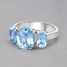 "Blue Topaz Ring, 3 Stone Oval Blue Topaz Ring, Sterling Silver Ring, Blue Topaz Silver Ring, December Birthstone Ring Flaunt yourself with this blue topaz 3 stone ring. The natural gemstones have a combined weight of 4.45 carats and are set in .925 sterling silver with rhodium plating. The soft blue hue of this ring adds a pop of color to any look! The understated design and vibrant stones make this ring perfect for every occasion. .925 Sterling Silver Stone Details: Blue Topaz Item Type: Ring Blue Topaz Three-stone Ring, Blue Topaz Three Stone Round Ring, Oval Blue Topaz Three Stone Ring, Blue Oval Topaz Ring With Three Stones, Cushion Solitaire Ring, Blue Topaz Ring Sterling Silver, Ring 3 Stone, Gemstone Solitaire Ring, Sky Blue Topaz Ring