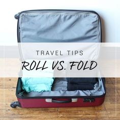 an open suitcase with clothes in it and the words travel tips roll vs fold on top