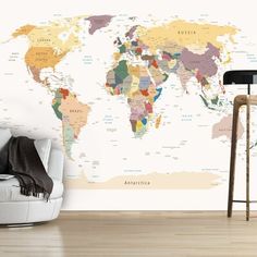 a living room with a white couch and large wall map