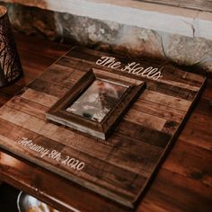 a wooden table topped with pictures and candles