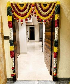 an entrance decorated with flowers and decorations