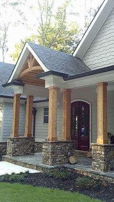 a house with stone pillars and columns on the front porch