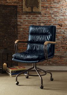 a black office chair sitting in front of a brick wall with a book on the floor