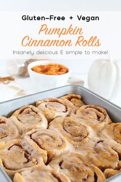 gluten - free and vegan pumpkin cinnamon rolls in a baking pan on a table