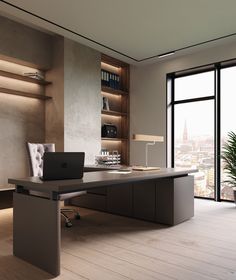 an office desk with a laptop on it in front of a large window overlooking the city