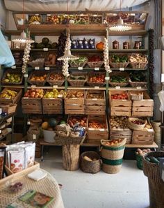 a store filled with lots of different types of fruits and veggies on shelves