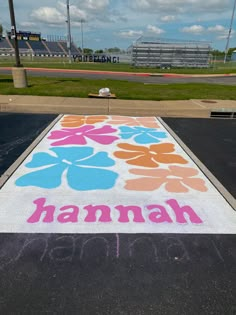 a chalk drawing on the ground in front of an empty parking lot that says hannah