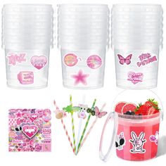 plastic cups with stickers, strawberries, and paper straws in them are shown