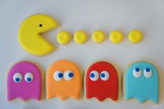 decorated cookies in the shape of pacman's and ghost's with googly eyes