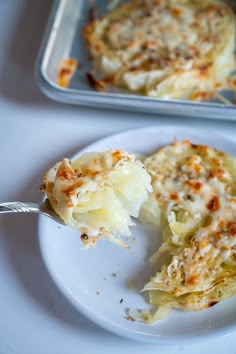 a white plate topped with lasagna covered in cheese