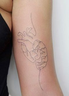 a woman's arm with a tattoo on it that has an outline of a hand holding a flower