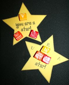 three yellow stars with words written on them