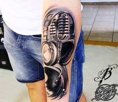 a man with a microphone tattoo on his arm